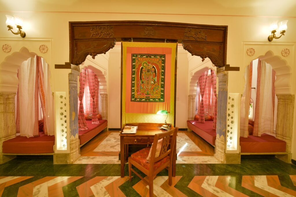 Living the Rajasthani Way Inside Dera Mandawa’s Heritage Suites 1 Traditional interior of Dera Mandawa’s heritage suites in Jaipur with carved arches and alcove seating