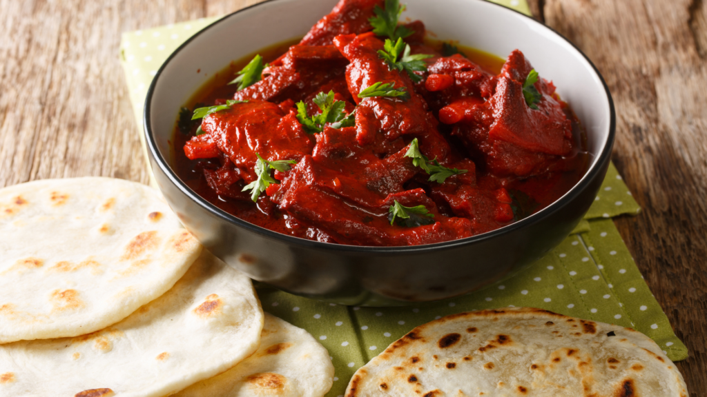 Traditional Lal Maas served with Indian flatbreads at a palace restaurant in Jaipur