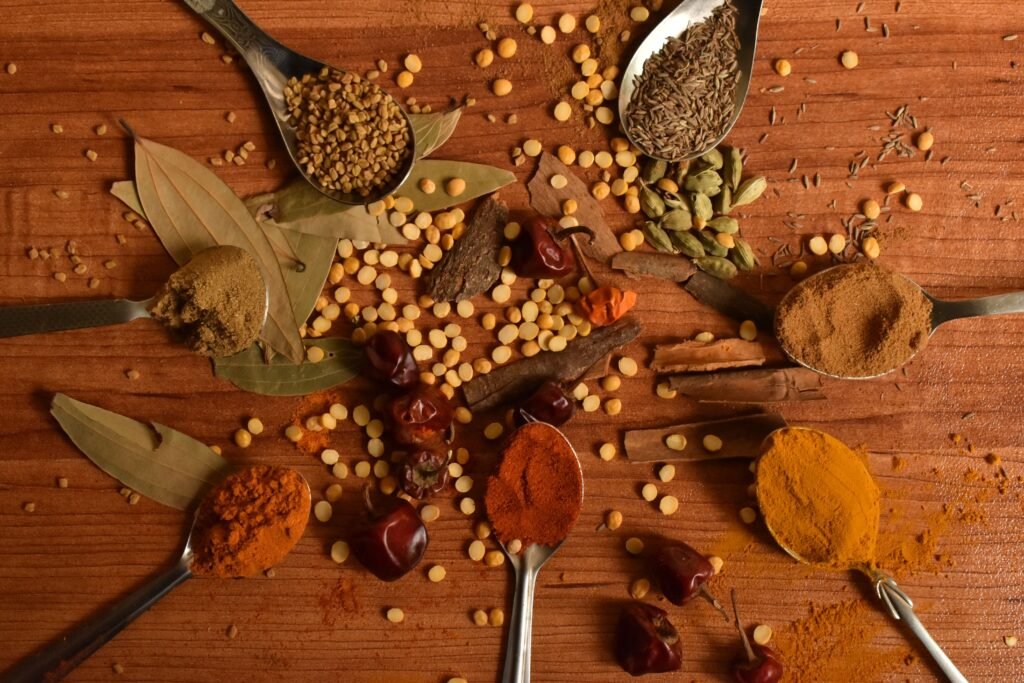 Gourmet Rajasthani Cooking at a Heritage Hotel 3 Colourful Indian spices arranged on a wooden surface