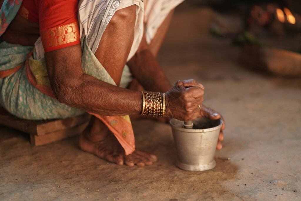 Gourmet Rajasthani Cooking at a Heritage Hotel 2 Hands grinding spices with a traditional mortar and pestle