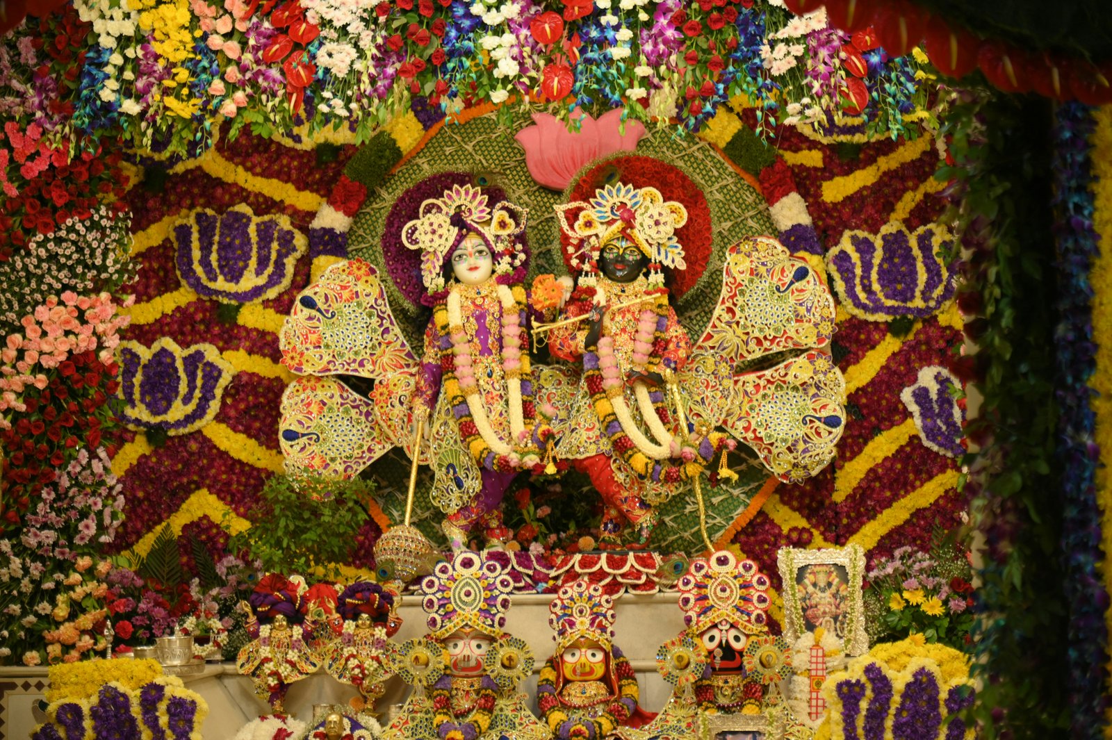 Krishna and Radha idols decorated with flowers at a spiritual place in Jaipur