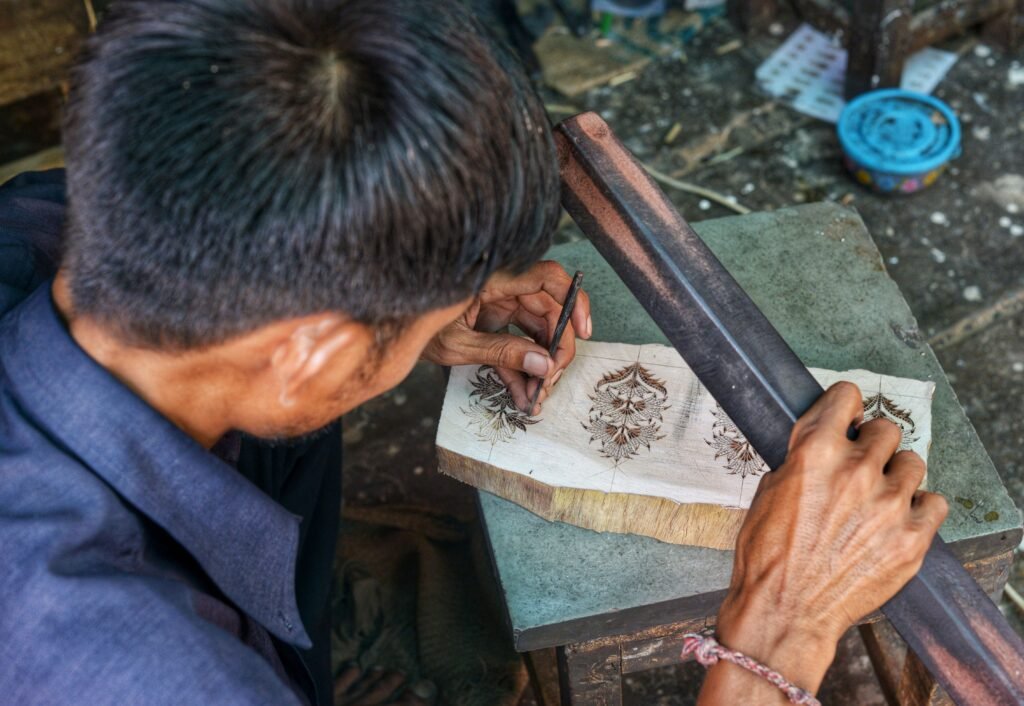Jaipur artisan carving a wooden printing block in a local craft workshop