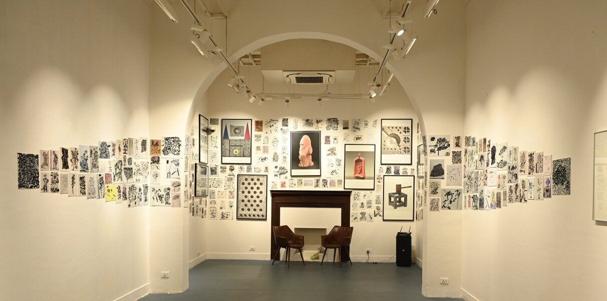 Art exhibition inside a Jaipur gallery showcasing contemporary sketches and installations during the winter cultural season | DeraMandawa