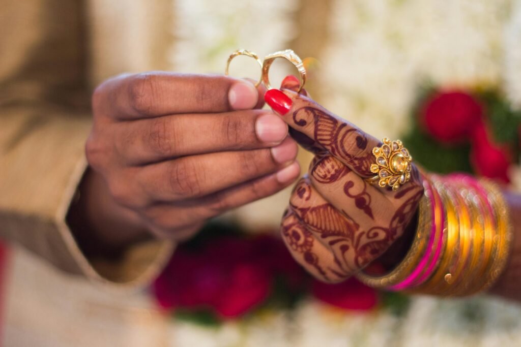Jaipur Wedding Favours Guests Will Keep 7 A close-up of a traditional Indian wedding in jaipur ceremony where the couple is exchanging gold rings.