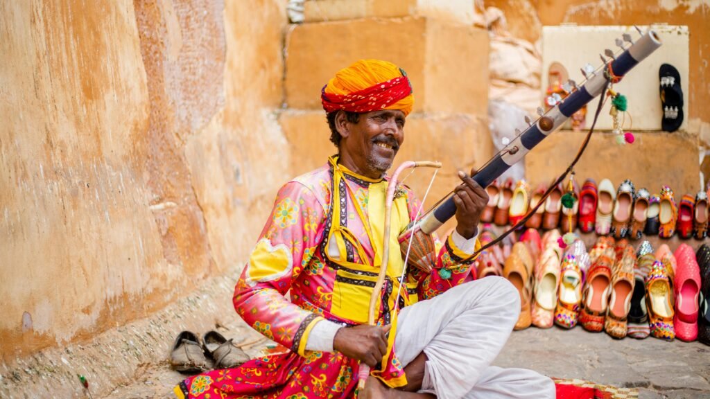 The Guardians of Dwindling Arts: Traditional Craftsmen of Rajasthan 4 A folk musician playing the ravanhatta beside rows of embroidered leather mojaris