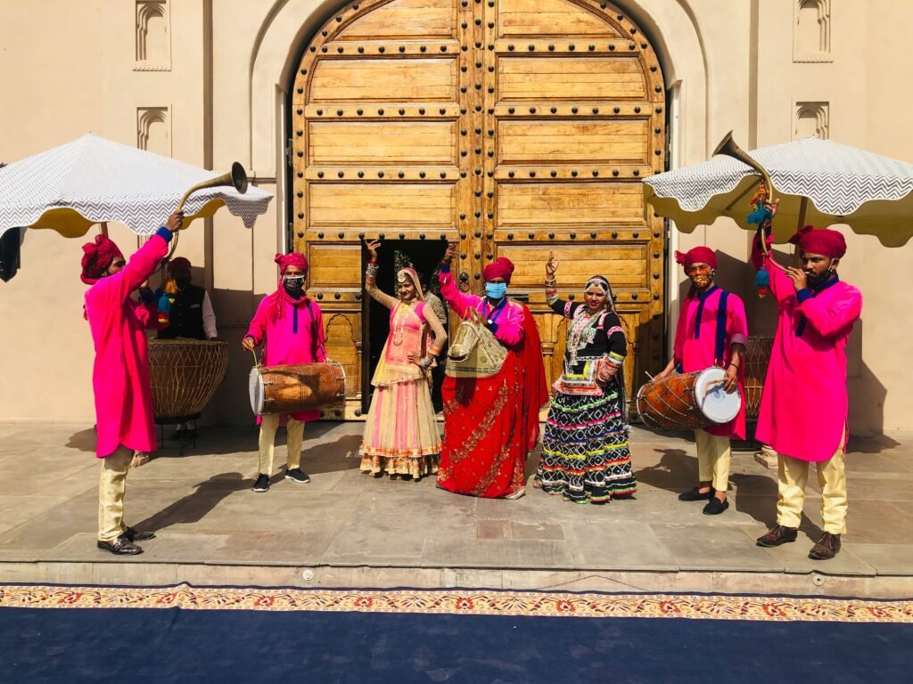 This image shows a traditional Indian welcome ceremony, likely at a hotel or wedding venue in Jaipur, Rajasthan | Wedding Venue in Jaipur - Dera Mandawa