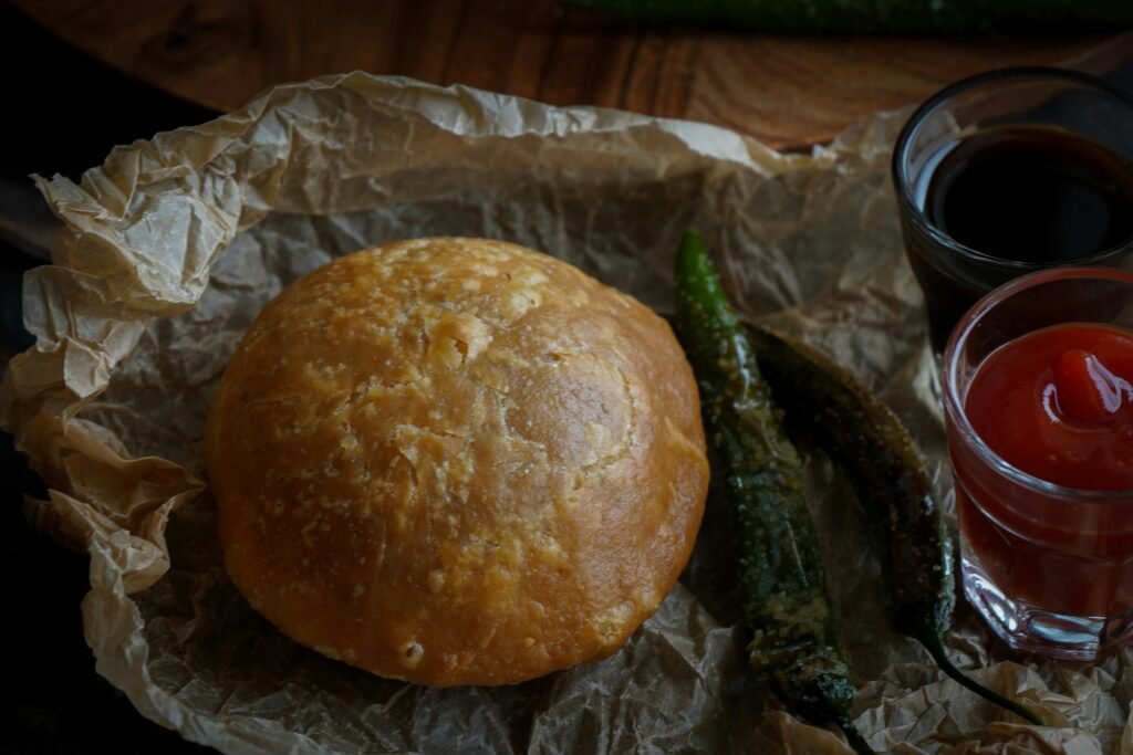Famous Jaipur pyaaz kachori served with chutneys and fried green chillies