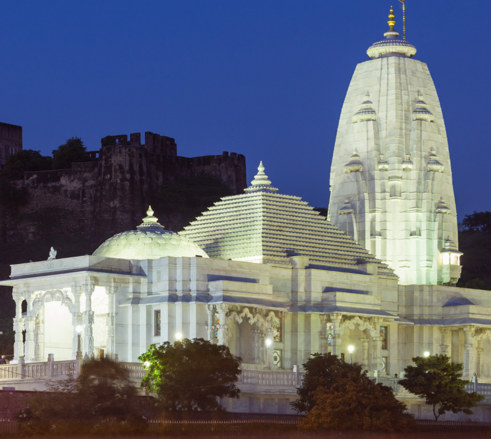 Birla Mandir 8 the magnificent Birla Mandir (also known as the Laxmi Narayan Temple) in Jaipur, Rajasthan, beautifully illuminated at dusk with the historic Moti Dungri fort visible in the background.