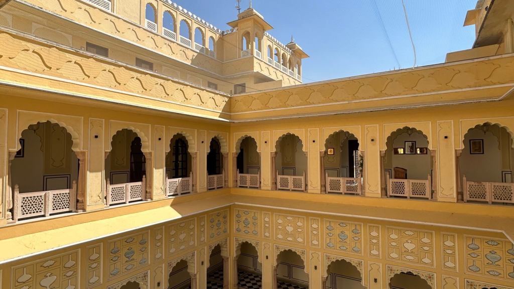 How a Nineteenth-Century Haveli Is Kept Alive 1 Interior chowk courtyard with hand-painted arches and carved jaali screens | Rajasthani haveli