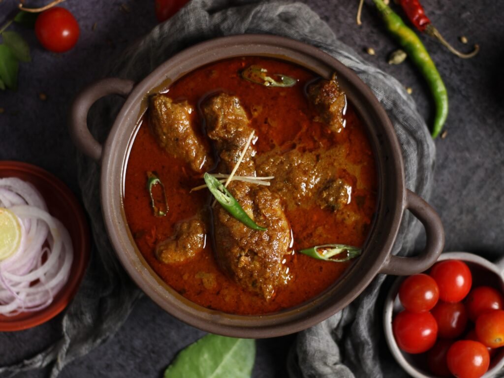 Slow-cooked Indian mutton curry served in a traditional clay pot