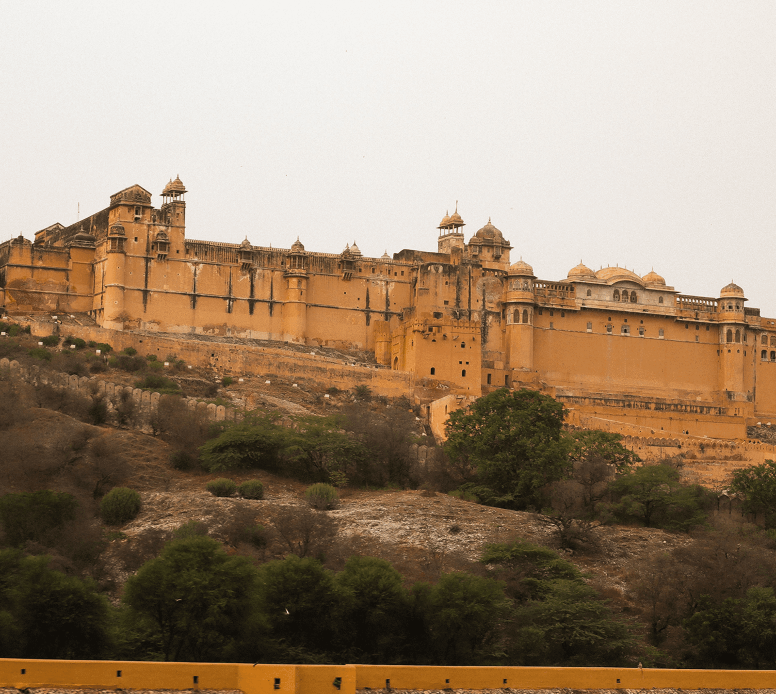 Galtaji Temple in Jaipur by taking a taxi, auto-rickshaw, or Uber from the city center