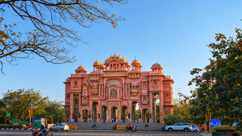 Pink domed arches of Patrika Gate at the entrance to Jawahar Circle in Jaipur, framed by trees