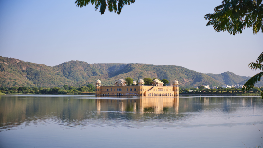 Jal Mahal reflected in calm Man Sagar Lake against green Aravalli hills, showing why winter is the best time to visit Jaipur
